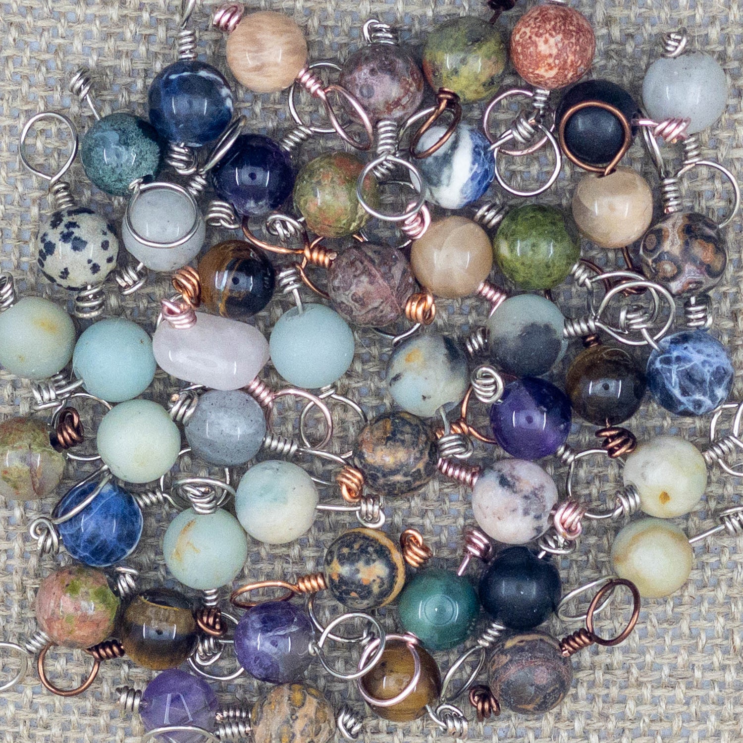 selection of handmade stone stitch markers for knitting
